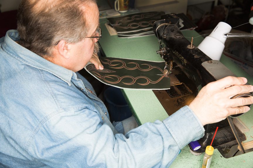 Smith sews vamps, counters, stitch work and pull straps onto each pair of custom-made boots with sewing machines original to the company.