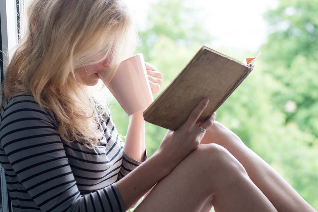 Woman sitting and enjoying book reading