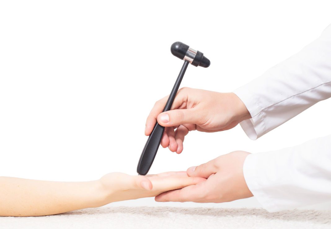 The doctor checks the palmar chin reflex in the palm of the patient. Verification and treatment of vegetative vascular dystonia and Parkinson's disease, copy space